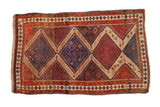 Antique Persian Hamadan rug with a central column of geometric medallions in red, blue, and camel hair.