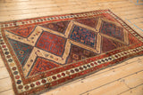 Antique Hamadan rug featuring a column of stepped medallions in rich chestnut, red, and mallard green.