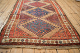 A view along the central column of geometric medallions on a fine antique Hamadan rug.