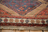 Detail of an antique Hamadan rug's floral top-view border and original, intact side cord selvage.