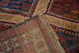 Corner view of the antique Hamadan rug revealing its hand-knotted back and original selvage.