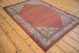 Angled vintage Serbend rug, cherry red boteh field and sapphire blue pawn motif borders.