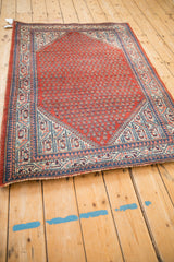 Corner of vintage Persian Serbend rug, red field, blue and ivory pawn motif border.