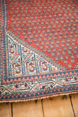 Serbend rug corner, cherry red field with botehs, sapphire blue and ivory pawn border.
