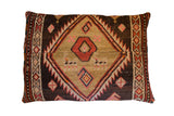 Antique tribal hand-knotted rug fragment pillow, geometric diamond in brown, beige, and red.