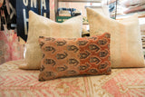 Malayer rug fragment pillow with intricate tribal patterns, abrash, and wool pile.