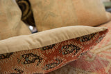 Close-up of Malayer rug fragment pillow showing brick red wool pile and abrash.