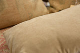 Subtly textured, light beige fabric back of the Vintage Rug Fragment Pillow.