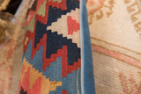 Vintage Kilim fragment pillow, geometric pattern in navy, red, cream, and blue side piping.