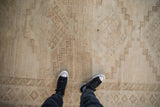 Detail of a distressed Kars carpet pile, showcasing faded geometric patterns and neutral colors.