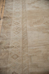 Distressed short pile of a vintage Kars rug with muted beige and sand tones.