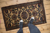 Overhead view providing scale for a vintage Mehriban rug with floral and boteh designs.