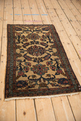 Vintage Persian Mehriban runner at an angle, displaying its central floral design and detailed borders.