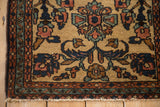 Corner detail of a vintage Mehriban rug with primitive blossoms and a seeded, meandering vine border.