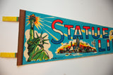 Angled view of the vintage felt pennant showing vibrant Statue of Liberty graphic.