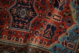 Close-up of a vintage Tajabad rug showing its soft wool pile and geometric patterns.