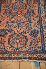 Vintage Lilihan rug's terracotta field with sapphire blue and ivory millefleur floral sprays.