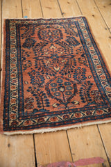 Lilihan rug detail: terracotta field, sapphire blue millefleur sprays, patterned border.