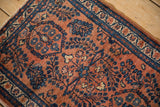 Finely hand-knotted vintage Lilihan rug with terracotta field and sapphire millefleur floral sprays.