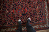 Overhead view of the vintage Hamadan rug, showing the rich Herati pattern and texture underfoot.