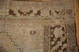 Distressed Oushak carpet corner with heavy abrash, visible foundation, and intact side selvage.