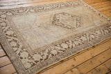 Distressed Oushak carpet with prominent abrash texture, ivory and coffee brown diamond medallion.
