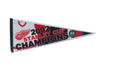 Vintage Detroit Red Wings 2002 Stanley Cup Champions felt pennant with red, black text, 12x30.