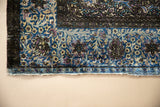 Supple silk pile showing the antique Kashan's European-style border in violet, blue, and gold.
