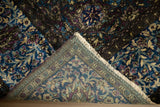 Fine construction of a collector silk Kashan, showing the dense back weave and lustrous dark pile.