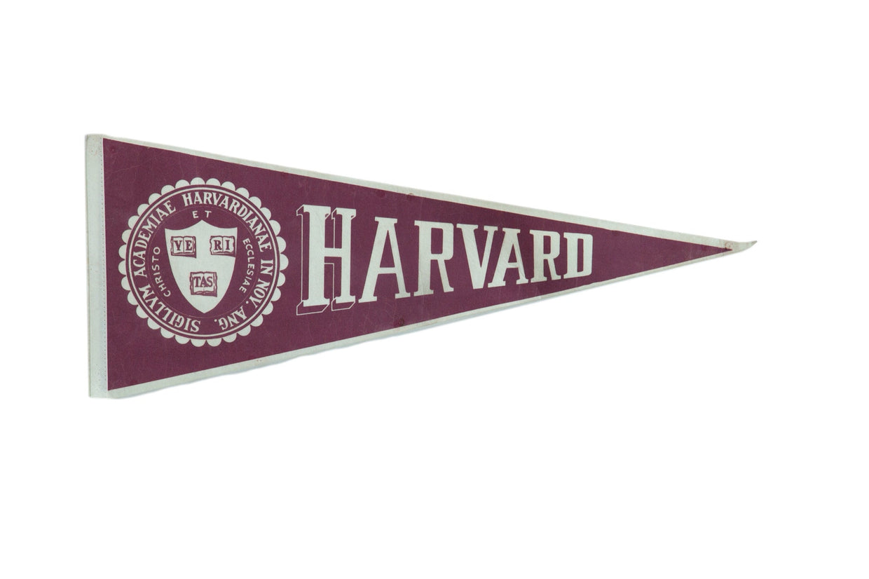 Vintage Harvard felt pennant in maroon and white, with academic seal and bold text.