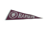 Vintage Harvard felt pennant close-up, showing seal, burgundy color, and edge wear.