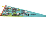 Detailed view of the Grand Hotel and Arch Rock illustrations on a vintage Mackinaw City pennant.
