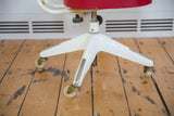 Ivory cream metal base of the Okamura swivel chair with silver pleated legs and rolling casters.