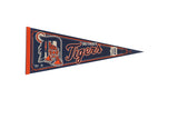 Vintage Detroit Tigers felt pennant in navy blue with orange and white tiger mascot graphics.
