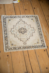 Angled perspective of the vintage distressed Oushak mat highlighting its central medallion.