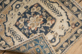 Distressed Oushak rug corner, showing worn pile, visible knot heads, and patterned reverse.