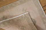 View of the rug's back showing the hand-knotted foundation and secure machine-bound edge.