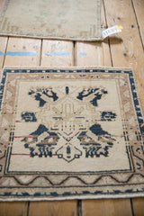 Angled view highlighting the vintage Oushak mat's geometric medallion and border details.