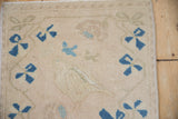 Worn pile of vintage Oushak rug, showing sapphire and powder blue checkered floral motifs.