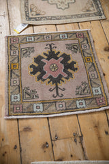 Vintage distressed Oushak square rug with faded mauve and charcoal palmette design.