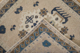 Folded corner of a vintage Oushak mat showing the machine-bound edge and wave border.