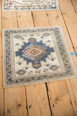 Distressed vintage Oushak rug with ivory, dusty blue, pale copper gul and vine border.