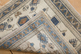 Distressed vintage Oushak rug pile with ivory, dusty blue, copper patterns and machine-bound reverse side.