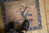 Close-up of distressed Oushak rug with abrashed dusty rose field and sapphire palmette border.