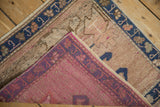 Distressed vintage Oushak rug pile with dusty blue border and magenta hand-knotted reverse.