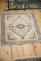 Distressed Oushak rug corner, beige and dusty blue meandering vine border, stepped contour.