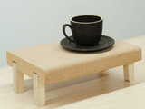 Matte black ceramic mug and saucer, showing handmade textured finish and natural rim.