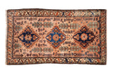 Vintage Mehriban rug with three sapphire diamond medallions on a dusty rose field of stylized shrubs.