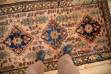 High sheen wool pile of a fine Mehriban rug showing sapphire blue and dusty rose diamond medallions.