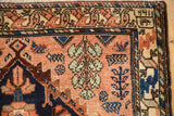 Detail of a weaver's insignia and date in the corner border of a Persian Mehriban collector rug.